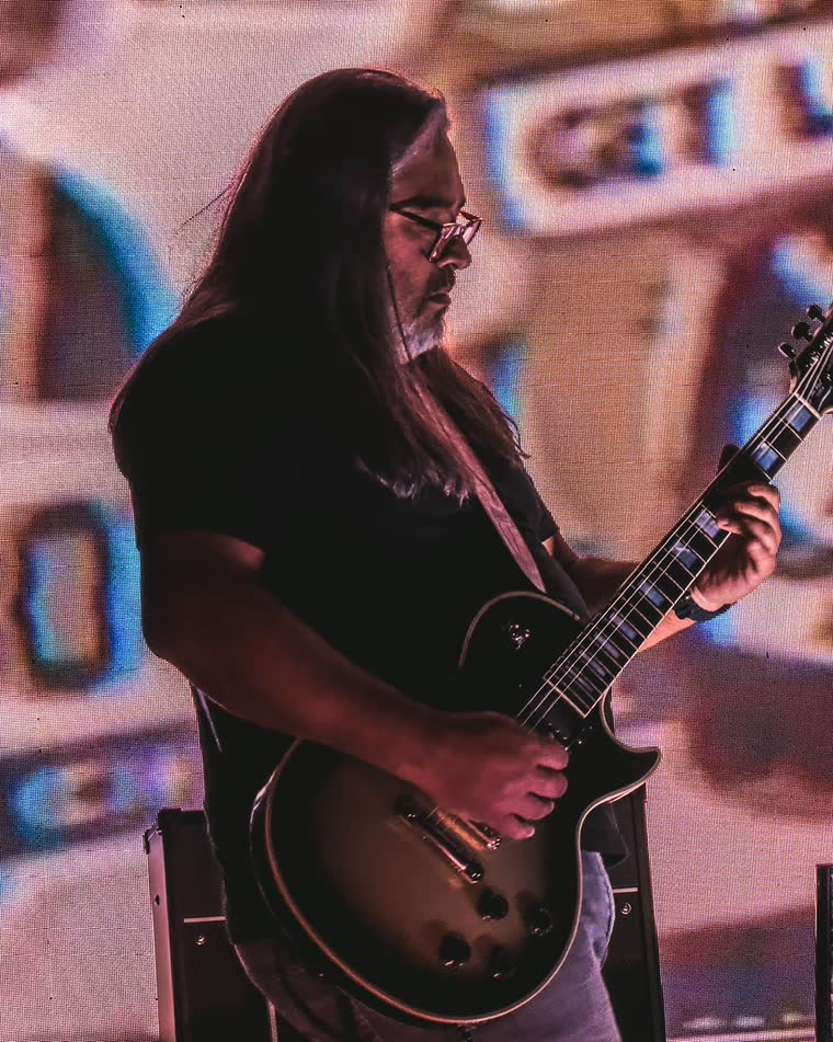 Marcos playing lead guitar on stage